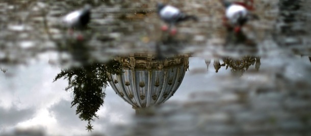 A picture taken on January 16, 2013 in Vatican shows the dome of the Saint Peter Basilica by reflection in a puddle. AFP PHOTO / GABRIEL BOUYS (Photo credit should read GABRIEL BOUYS/AFP/Getty Images)