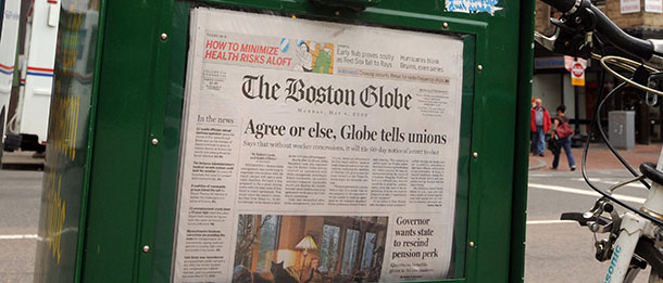 BOSTON - MAY 4: A Boston Globe newpaper sits inside a vendor box May 4, 2009 in downtown Boston, Massachusetts. Negotiations between the New York Times, The Globes parent company, and the newspapers largest union continued past a mid-night deadline with no deal. and cpmpany had threatened to shut down the paper if it's unions did not agree to $20 million in cuts. A deal was reached with six other unions. (Photo by Darren McCollester/Getty Images)