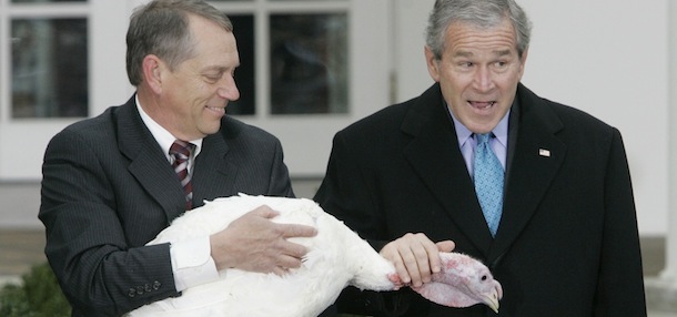 President Bush, right, pets 'Flyer' after pardoning the National Thanksgiving turkey during a ceremony in the Rose Garden of the White House, Wednesday, Nov. 22, 2006, in Washington. Holding the turkey is Lynn Nutt, left, from Springfield, Mo. (AP Photo/Pablo Martinez Monsivais)