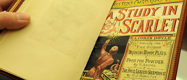 Tim Johnson, curator of special collections and rare books at the University of Minnesota Libraries holds an original copy of A Study in Scarlet, written by Sir Arthur Conan Doyle which is the first story to feature the character of Sherlock Holmes, at the Elmer L. Anderson Library on Nov. 23, 2009 at the University of Minnesota in Minneapolis. The book is one of more than 60, 000 items in the Sherlock Holmes collection at the University of Minnesota which is home to just about everything and anything pertaining to Sherlock Holmes including original books and manuscripts from the early Holmes stories and pop culture items like the Sesame Street character Sherlock Hemlock. (AP Photo/Dawn Villella)