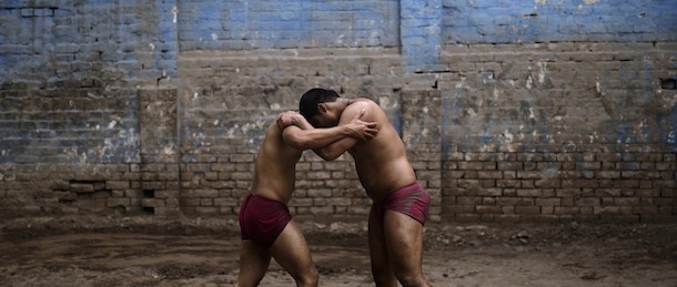 Pakistani Kushti wrestlers fight in the ring, during their daily training, at a wrestling club in Lahore, Pakistan, Tuesday, Feb. 26, 2013. Kushti, an Indo-Pakistani form of wrestling, is several thousand years old and is a national sport in Pakistan. (AP Photo/Muhammed Muheisen)
