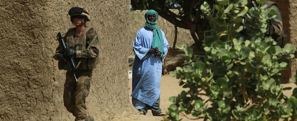 A French soldier secures the area where a suicide bomber attacked, at the entrance of Gao, northern Mali, Sunday Feb. 10, 2013. It was the second time a suicide bomber targeted the Malian army checkpoint in three days. (AP Photo/Jerome Delay)