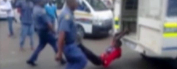 In this still frame from TV and courtesy of South African Daily Sun newspaper, showing a South African man with his hands tethered to the back of a police vehicle being dragged behind as police hold his legs up and the vehicle apparently drives off, east of Johannesburg Tuesday Feb. 26, 2013. The man died of his injuries. In video filmed on a mobile phone, uniformed police are seen trying to subdue the man, then tethering him to the back of a police vehicle which drives off, watched by a large crowd. Moses Dlamini of the Independent Police Investigative Directorate said early Thursday Feb. 28 2013 on ENCA TV network that his service has opened a murder probe. (AP Photo/The Daily Sun) TV OUT