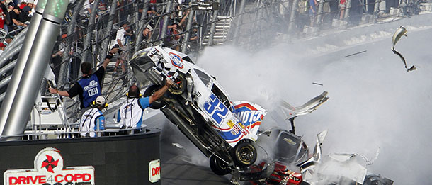 Kyle Larson's car (32) gets airborne during a multi-car wreck on the final lap of the NASCAR Nationwide Series auto race Saturday, Feb. 23, 2013, at Daytona International Speedway in Daytona Beach, Fla. Larson's car hit the safety fence sending car parts and other debris flying into the stands injuring spectators. (AP Photo/David Graham)
