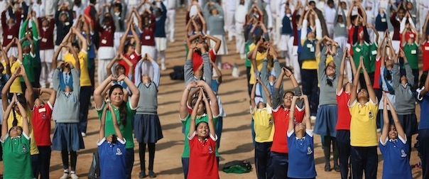 Indian school children perform Surya Namaskar or Sun salutation during a function to mark 150th birth anniversary of Swami Vivekananda, in New Delhi, India, Monday, Feb. 18, 2013. Hundreds of school children across India performed Surya Namaskar, a Yoga posture which comprises 12 different bodily postures that ought to be performed in particular sequence. Swami Vivekananda, an Indian Hindu monk, who spread the message of India's spiritual heritage across the world. (AP Photo/Manish Swarup)