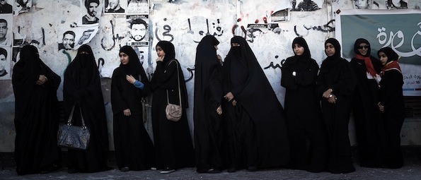 Bahraini Shiite Muslim women, some of whom are wearing the niqab, stand watching an anti-government rally to demand reforms in the village of Malikiya, South of Manama, on February 3, 2013, . The Gulf state has been shaken by unrest since its forces in March 2011 crushed a month of popular Shiite-led protests demanding greater rights and an end to what they said was discrimination by the Sunni royals. AFP PHOTO/MOHAMMED AL-SHAIKH (Photo credit should read MOHAMMED AL-SHAIKH/AFP/Getty Images)