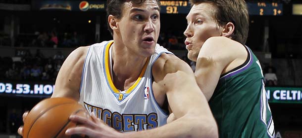 Denver Nuggets forward Danilo Gallinari, left, of Italy, drives past Milwaukee Bucks forward Mike Dunleavy in the fourth quarter of the Nuggets' 112-104 victory in an NBA basketball game in Denver, Tuesday, Feb. 5, 2013. (AP Photo/David Zalubowski)