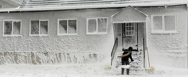 WINTHROP, MA - FEBRUARY 9: A man shovels snow along Winthrop Shore Drive February 9, 2013 in Winthrop, Massachusetts. The powerful storm has knocked out power to 650,000 and dumped more than two feet of snow in parts of New England. (Photo by Darren McCollester/Getty Images)