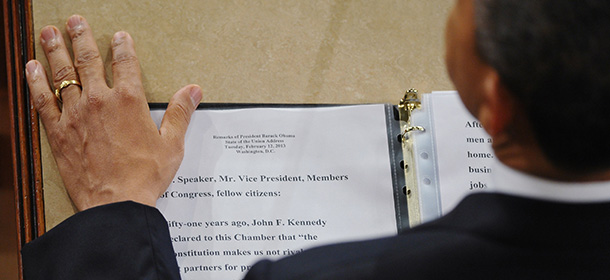 US President Barack Obama rests his hand next to a copy of his speech as he delivers his State of the Union address before a joint session of Congress on February 12, 2013 at the US Capitol in Washington, DC. AFP PHOTO/Mandel NGAN (Photo credit should read MANDEL NGAN/AFP/Getty Images)