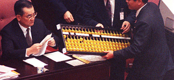 TAIPEI, TAIWAN - APRIL 1: Parliamentarian Chao Yung-Ching (R) from the ruling Kuomintang presents a giant abacus to Premier Lien Chan at a legislative session in Taipei 01 April 1994, asking Lien to be stringent in issuing bonds to avoid worsening the government's financial burden in the fiscal year begining 01 July. (Photo credit should read STR/AFP/Getty Images)