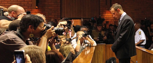 Olympic athlete Oscar Pistorius stands in the dock during his bail hearing at the magistrates court in Pretoria, South Africa, Friday, Feb. 22, 2013. The fourth and likely final day of Oscar Pistorius' bail hearing opened on Friday, with the magistrate then to rule if the double-amputee athlete can be freed before trial or if he has to remain in custody over the shooting death of his girlfriend. (AP Photo/Themba Hadebe)