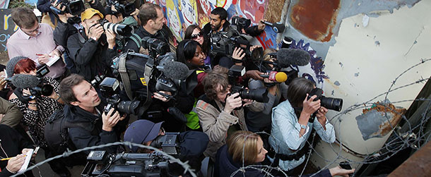 BASILDON, ENGLAND - SEPTEMBER 19: Reporters and television crews gather at a barricade to interview residents at Dale Farm travellers camp on September 19, 2011 in Basildon, England. Eviction of 80 traveller famillies has begun after a 10 year legal battle to clear the site of illegal dwellings. Residents and activists have built defences all around the site to resist bailiffs. (Photo by Peter Macdiarmid/Getty Images)