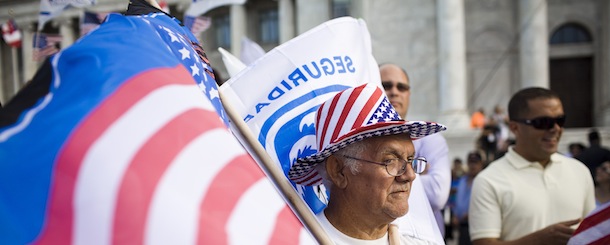 SAN JUAN, PUERTO RICO - MARCH 16: 
Roberto Maldonado, 75, sells flags at a New Progressive Party rally where Republican presidential candidate, former Massachusetts Gov. Mitt Romney was campaigning on the North Side of the Capitol building March 16, 2012 in San Juan, Puerto Rico. Luis Fortuno, the island's governor and a Republican, has already expressed his support for the former governor for president. Romney's two-day campaign on the island is meant to win the 23 GOP delegates up for grabs on the U.S. territory. Romney's fiscal views are likely to resonate with the island's large private sector. (Photo by Christopher Gregory/Getty Images)