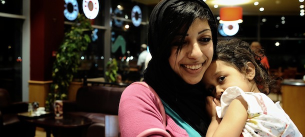 Bahraini opposition activist Zainab al-Khawaja, daughter of prominent jailed opponent Abdulhadi al-Khawaja, holds her daughter Jude as they sit in a coffee shop in the village of Abu Saiba, West of Manama, on May 29, 2012. Zainab has been released on bail one month after she was arrested and she still faces charges related to organising rallies in Bahrain. AFP PHOTO/MOHAMMED AL-SHAIKH (Photo credit should read MOHAMMED AL-SHAIKH/AFP/GettyImages)