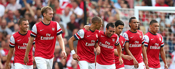 LONDON, ENGLAND - SEPTEMBER 15: Arsenal players celebrate after Nathaniel Clyne of Southhampton scores an own goal to make it 4-0 in the first half during the Barclays Premier League match between Arsenal and Southampton at Emirates Stadium on September 15, 2012 in London, England. (Photo by Clive Mason/Getty Images)