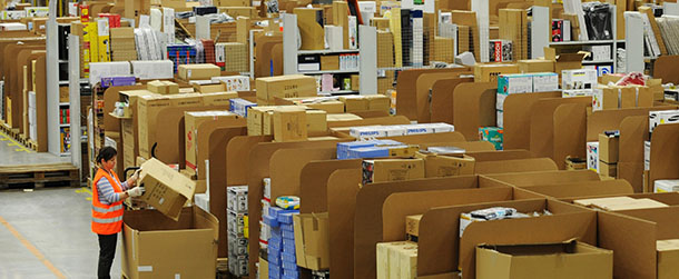 Picture taken on December 20, 2010 shows an employee packing a parcel at the logistics centre of US online retail giant Amazon in Bad Hersfeld, central Germany. Amazon said on February 18, 2013 it had cut ties with a security firm at the centre of allegations that foreign seasonal staff hired in Germany by Amazon were harassed and intimidated.AFP PHOTO / UWE ZUCCHI GERMANY OUT (Photo credit should read UWE ZUCCHI/AFP/Getty Images)