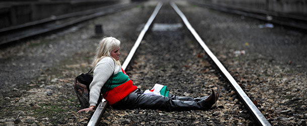 A protester sits on the tracks during a blockade of the railway next to Sofia Central railway station as part of anti-monopoly protest in Sofia on March 10, 2013. Hundreds of Bulgarians joined new rallies across the country on Sunday to protest against poverty and corruption and denounce the whole political establishment. AFP PHOTO / NIKOLAY DOYCHINOV (Photo credit should read NIKOLAY DOYCHINOV/AFP/Getty Images)