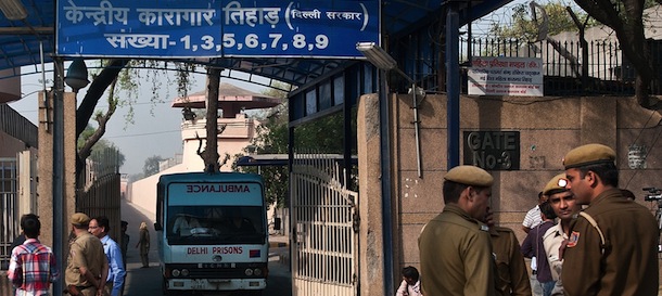 Indian policemen stand guard as an ambulance leaves the main entrance of Tihar Jail in New Delhi on March 11, 2013. The main accused in the fatal gang-rape of a student on a bus in New Delhi in December 2012, has reportedly been found hanged in jail on March 11, 2013, while in solitary confinement, prompting outrage from the victim's family. Ram Singh, one of six people on trial over the shocking attack, was found dead shortly before dawn after making a noose out of his clothing, according to officials at Delhi's top-security Tihar jail.bb AFP PHOTO/ MANAN VATSYAYANA (Photo credit should read MANAN VATSYAYANA/AFP/Getty Images)