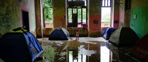 A Brazilian native girl walks inside the former Indigenous Museum --aka Aldea Maracana-- next to the Maracana stadium in Rio de Janeiro on March 18, 2013. Indigenous people have been occupying the place since 2006, which is due to be pulled down to construct 10,500 parking lots for the upcoming Brazil 2014 FIFA World Cup. AFP PHOTO / CHRISTOPHE SIMON (Photo credit should read CHRISTOPHE SIMON/AFP/Getty Images)