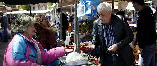 People buy goods from a vegetable market, in central Nicosia, on Saturday, March 23, 2013. Politicians in Cyprus were racing Saturday to complete an alternative plan raising funds necessary for the country to qualify for and international bailout, with a potential bankruptcy just three days away. (AP Photo/Petros Giannakouris)