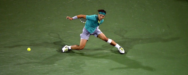 Rafael Nadal, right, of Spain, returns a shot to Roger Federer, of Switzerland, during their match at the BNP Paribas Open tennis tournament, Thursday, March 14, 2013, in Indian Wells, Calif. Nadal won 6-4, 6-2. (AP Photo/Mark J. Terrill)