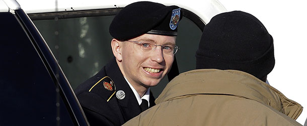 FILE - In this Nov. 28, 2012 file photo, Army Pfc. Bradley Manning, center, steps out of a security vehicle as he is escorted into a courthouse in Fort Meade, Md., for a pretrial hearing. A military judge hears closing arguments on Tuesday, Dec. 12, 2012, on whether a private charged with sending classified material to WikiLeaks suffered illegal pretrial punishment during nine months in a Marine Corps brig. Army Pfc. Bradley Manningâs lawyers claim his treatment was so egregious that all charges should be dismissed. (AP Photo/Patrick Semansky, HO)