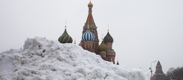 People walk through snow covered Red Square after a snowstorm in Moscow, Russia, Monday, March 25, 2013, with the St. Basil Cathedral in the background. A heavy snowfall has continued for the second day in Moscow with temperatures hovering around -8 degrees Celsius (17 F). (AP Photo/Alexander Zemlianichenko)