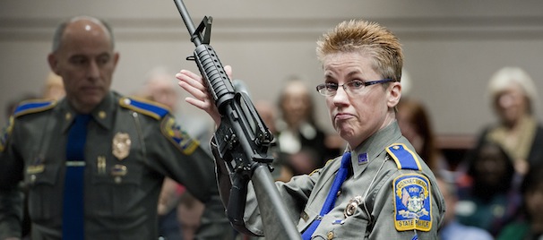 Firearms Training Unit Detective Barbara J. Mattson of the Connecticut State Police holds up a Bushmaster AR-15 rifle, the same make and model of gun used by Adam Lanza in the Sandy Hook School shooting, for a demonstration during a hearing of a legislative subcommittee reviewing gun laws, at the Legislative Office Building in Hartford, Conn., Monday, Jan. 28, 2013. The parents of children killed in the Newtown school shooting called for better enforcement of gun laws Monday at the legislative hearing. (AP Photo/Jessica Hill)