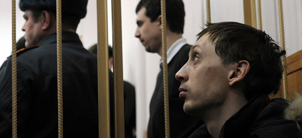 Pavel Dmitrichenko, a leading dancer at Russia?s Bolshoi Theatre, looks on as he sits inside the defendant's cage during a court hearing in Moscow on March 7, 2013. Dmitrichenko appeared today in court after confessing to planning the acid attack on the ballet troupe?s artistic director Sergei Filin, reportedly in revenge for his treatment of his dancer girlfriend. AFP PHOTO / ANDREY SMIRNOV (Photo credit should read ANDREY SMIRNOV/AFP/Getty Images)