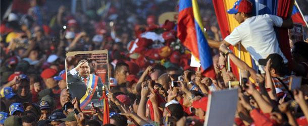 Supporters accompany the funeral cortege of late Venezuelan President Hugo Chavez on its way to the Military Academy, on March 6, 2013, in Caracas. The flag-draped coffin of Venezuelan leader Hugo Chavez was borne through throngs of weeping supporters on Wednesday as a nation bade farewell to the firebrand leftist who led them for 14 years. AFP PHOTO/Leo RAMIREZ (Photo credit should read LEO RAMIREZ/AFP/Getty Images)