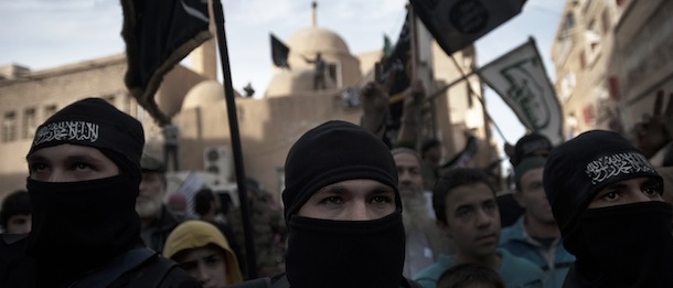 Members of Liwa (brigade) Hamzah, a newly formed Islamist brigade from the Syrian eastern city of Deir Ezzor take part in a rally in the centre of the city to announce their formation on February 25, 2013. Syria's opposition and foreign powers hold crucial talks in Rome with Washington suggesting it is ready to boost support to rebels in their struggle against President Bashar al-Assad. AFP PHOTO/ZAC BAILLIE (Photo credit should read ZAC BAILLIE/AFP/Getty Images)