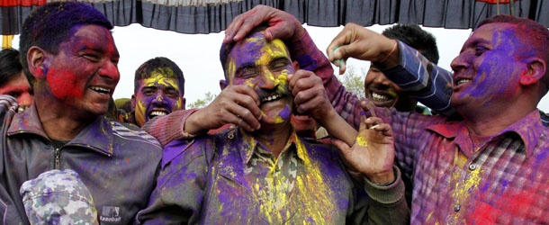 Indian Border Security Force soldiers smear colored powder on each other's faces as they celebrate Holi, inside their base camp on the outskirts of Srinagar, India, Wednesday, March 27, 2013. Holi, the Hindu festival of colors, heralds the arrival of spring. (AP Photo /Mukhtar Khan)