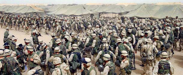 CAMP SHOUP, KUWAIT: TO GO WITH IRAQ-ANNIVERSARY PACKAGES (FILES) US Marines from the 2nd battalion/8 MAR, prepare themselves after receiving orders to cross the Iraqi border at Camp Shoup, northern Kuwait, 20 March 2003. Four years after a US-led invasion billed as a bid to disarm Iraq and create a democratic pro-Western enclave in the Middle East, commanders are in fact pouring 25,000 reinforcements into Baghdad to quell Sunni-Shiite fighting, the bloodiest element of the conflict and one which even the Pentagon admits now amounts to civil war. AFP PHOTO/Eric FEFERBERG (Photo credit should read ERIC FEFERBERG/AFP/Getty Images)