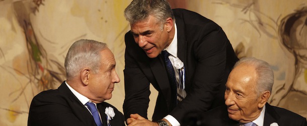 Israeli politician Yair Lapid (C), leader of the Yesh Atid party, shakes hand with Prime Minister Benjamin Netanyahu (L) as he sits next to President Shimon Peres during a reception marking the opening of the 19th Knesset (Israeli parliament) on February 5, 2013 in Jerusalem. Israeli Prime Minister Benjamin Netanyahu said a Bulgarian finding that Hezbollah was behind a deadly bombing in the country should push the EU to draw the "necessary conclusions" about the group, hinting it should be placed on a terror watch list. AFP PHOTO/GALI TIBBON (Photo credit should read GALI TIBBON/AFP/Getty Images)