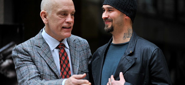 US actor John Malkovich (C) poses with Russian writer Lilin Nicolai during a photocall for his latest film "Educazione Siberiana" on 22 February 2013 in Rome. AFP PHOTO / TIZIANA FABI (Photo credit should read TIZIANA FABI/AFP/Getty Images)