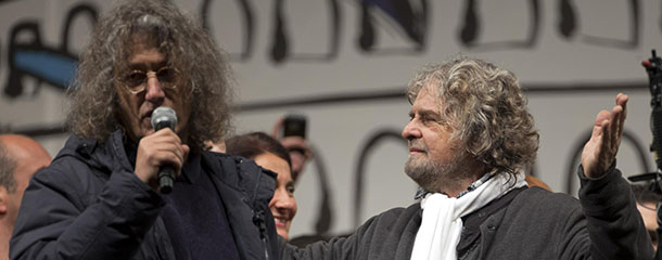 Italian comic-turned-political agitator Beppe Grillo and Gianroberto Casaleggio attend a rally in view of the upcoming general elections, in Rome, Friday, Feb. 22, 2013. Grillo fills piazzas from Milan to Rome, from Palermo to Verona with Italians who seem to get some catharsis from his rant against politician who drove the country to the brink of financial ruin, industrial managers whose alleged shenanigans are tarnishing prized companies and bankers who aided and abetted the other two classes of powerbrokers. (AP Photo/Andrew Medichini)