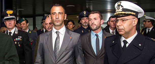 This Feb. 23, 2013 photo made available Wednesday, March 13, 2013 shows Italian marines Massimiliano Latorre, center left, followed by Salvatore Girone, second from right, upon their arrival from India at Rome's Leonardo da Vinci airport, in Fiumicino. India's prime minister demanded Wednesday that Italy return two marines accused of killing a pair of fishermen last year or face unspecified consequences, deepening a diplomatic dispute between the two countries. The Indian government allowed the marines to return home in February to vote in national elections and to celebrate Easter with a promise from the Italian ambassador that they would return to stand trial. Italy announced Monday it would not send them back. (AP Photo/Angelo Carconi)