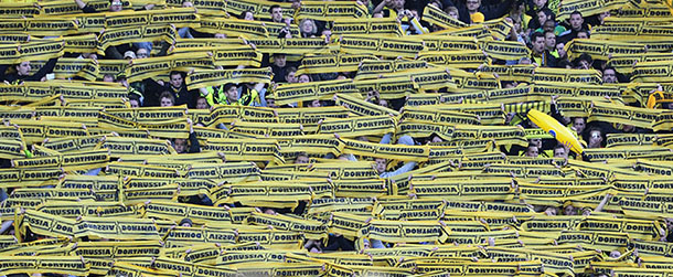 Supporters of Borussia Dortmund hold scarves to cheer their team prior to the German cup " DFB Pokal " final football match Borussia Dortmund vs Bayern Munich at the Olympiastadion in Berlin on May 12, 2012. 
 AFP PHOTO / JOHN MACDOUGALL (Photo credit should read JOHN MACDOUGALL/AFP/Getty Images)