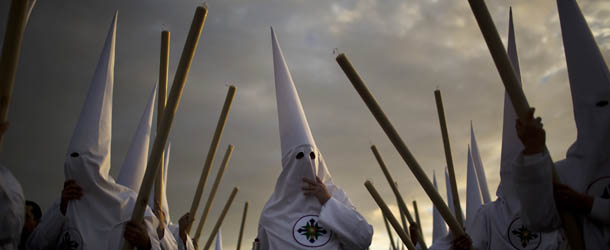 Penitents from "San Gonzalo" brotherhood take part in a procession in Seville, Spain, Monday, March 25, 2013. Hundreds of processions take place throughout Spain during the Easter Holy Week. (AP Photo/Emilio Morenatti)