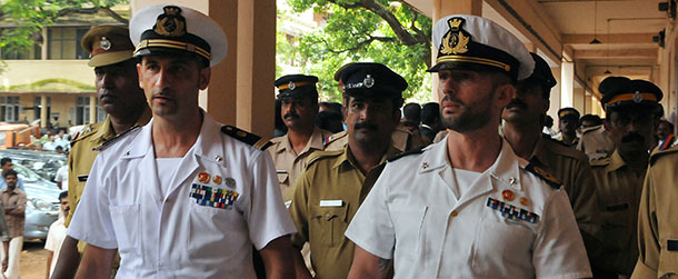 Italian marines Latore Massimiliano (2L) and Salvatore Girone (2R) are escorted by Indian police outside a court in Kollam on May 25, 2012. The two Italian marines have been charged with killing two fishermen who were allegedly mistaken for pirates and shot dead from an Italian oil tanker off India's south western coast. AFP PHOTO/ STR (Photo credit should read STRDEL/AFP/GettyImages)