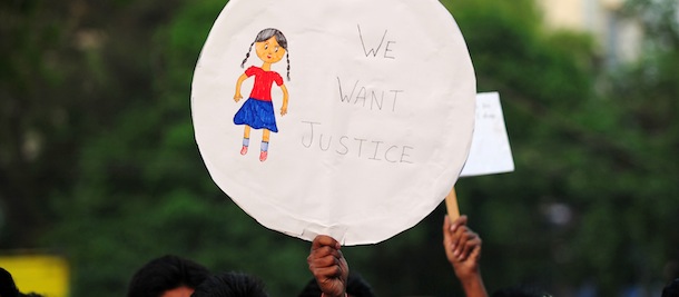 A placard is seen as demonstrators participate in a protest in Allahabad on April 23, 2013, following the rape of a five-year old girl in New Delhi. A senior Indian government minister said that a new rape outrage showed that "something terrible" was happening to society as he extended an olive branch to demonstrators. Protests have been taking place across New Delhi since last week when it emerged that a five-year-old girl had been repeatedly raped over the course of nearly two days after being abducted from her home in a working class suburb. AFP PHOTO/ SANJAY KANOJIA (Photo credit should read Sanjay Kanojia/AFP/Getty Images)
