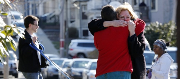 Neighbors hug outside the home of the Richard family in the Dorchester neighborhood of Boston, Tuesday, April 16, 2013. Martin Richard, 8, was killed in Mondays bombing at the finish line of the Boston Marathon. (AP Photo/Michael Dwyer)