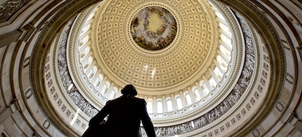The Rotunda of the U.S. Capitol is seen as Congress convenes to negotiate a legislative path to avoid the so-called "fiscal cliff" of automatic tax increases and deep spending cuts that could kick in Jan. 1., in Washington, Sunday, Dec. 30, 2012. A statue of President George Washington is seen in the foreground. (AP Photo/J. Scott Applewhite)