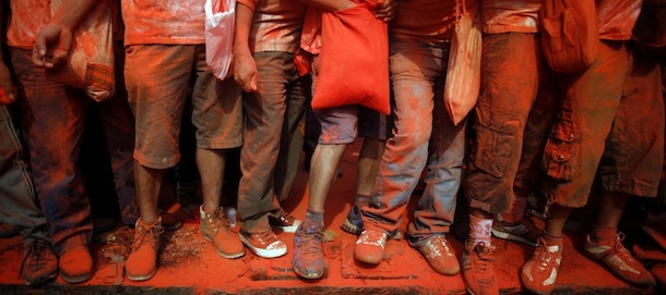 Nepalese devotees throw vermilion powder on each other during Sindur Jatra festival in Thimi, on the outskirts of Katmandu, Nepal, Monday, April 15, 2013. Sindur Jatra Festival, is celebrated to welcome the advent of spring and the New Year. (AP Photo/Niranjan Shrestha)