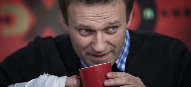 Russian opposition leader Alexey Navalny drinks tea while speaking to a journalist during an interview in the Echo Moskvy (Echo of Moscow) radio station in Moscow, Russia, Monday, April 8, 2013. Navalny made his name as an anti-corruption whistleblower and spearheaded massive anti-Kremlin protests that followed the rigged parliament election in Dec. 2011. (AP Photo/Alexander Zemlianichenko)