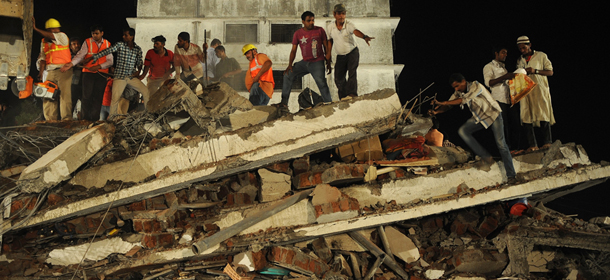 Indian rescue workers and local residents look for survivors at the site of building collapse in Mumbra, on the outskirts of Mumbai on April 4, 2013. Over twenty people have died and up to 50 more were injured when an unauthorised building under construction collapsed on the outskirts of Mumbai, Indian police said. AFP PHOTO/ PUNIT PARANJPE (Photo credit should read PUNIT PARANJPE/AFP/Getty Images)