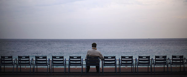 NICE, FRANCE - NOVEMBER 03: As the leaders of the world's richest nations discuss the global economy in nearby Cannes a man sits and looks out to sea on Promenade des Anglais on November 3, 2011 Nice, France. The Eurozone crisis and the Greek economy are dominating the first day of the G20 summit in Cannes after Greek Prime Minister George Papandreou called for a referendum on the Brussels bailout package of the Greek economy. (Photo by Christopher Furlong/Getty Images)