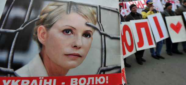 A protester holds on March 28, 2012 a picture of former Ukrainian Prime Minister and opposition leader Yulia Tymoshenko during a protest of her supporters demanding her release in front of the president's office in Kiev. Supporters of Tymoshenko on March 26 expressed grave concern for her health after a leaked medical report said she required urgent urgent hospitalization. AFP PHOTO/ SERGEI SUPINSKY (Photo credit should read SERGEI SUPINSKY/AFP/Getty Images)