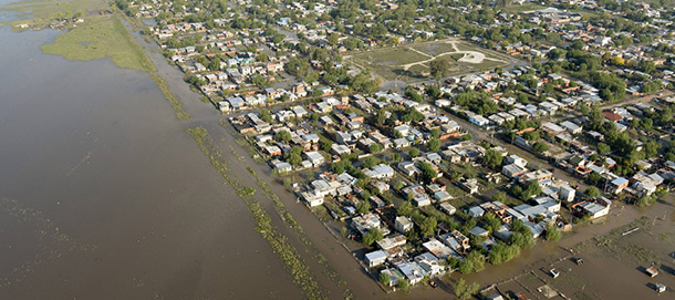 Aerial view of a flooded area in the outskirts of La Plata, Argentina, on April 3, 2013. Massive flooding killed 54 people in and around Buenos Aires, Argentine officials said Wednesday, with most of the victims being found after a second day of record rainfall hit the area. At least 46 people died as flood waters hit the nearby city of La Plata about 60 kilometers (40 miles) south of Buenos Aires, following historic rains that swept through the streets, submerging cars as people cowered on rooftops. AFP PHOTO/JUAN MABROMATA (Photo credit should read JUAN MABROMATA/AFP/Getty Images)