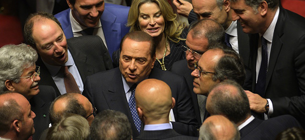 Former Italy's Prime Minister Silvio Berlusconi (C) chats with senators during a confidence vote for the new governement on April 30, 2013 at the senate in Rome. Italy's new prime minister will face an early test of his mission to reverse Europe's austerity course Tuesday as he meets German Chancellor Angela Merkel after vowing to stop a policy he says is killing his country. AFP PHOTO / ANDREAS SOLARO (Photo credit should read ANDREAS SOLARO,ANDREAS SOLARO/AFP/Getty Images)